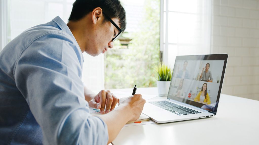 man with eye glasses working on laptop from home